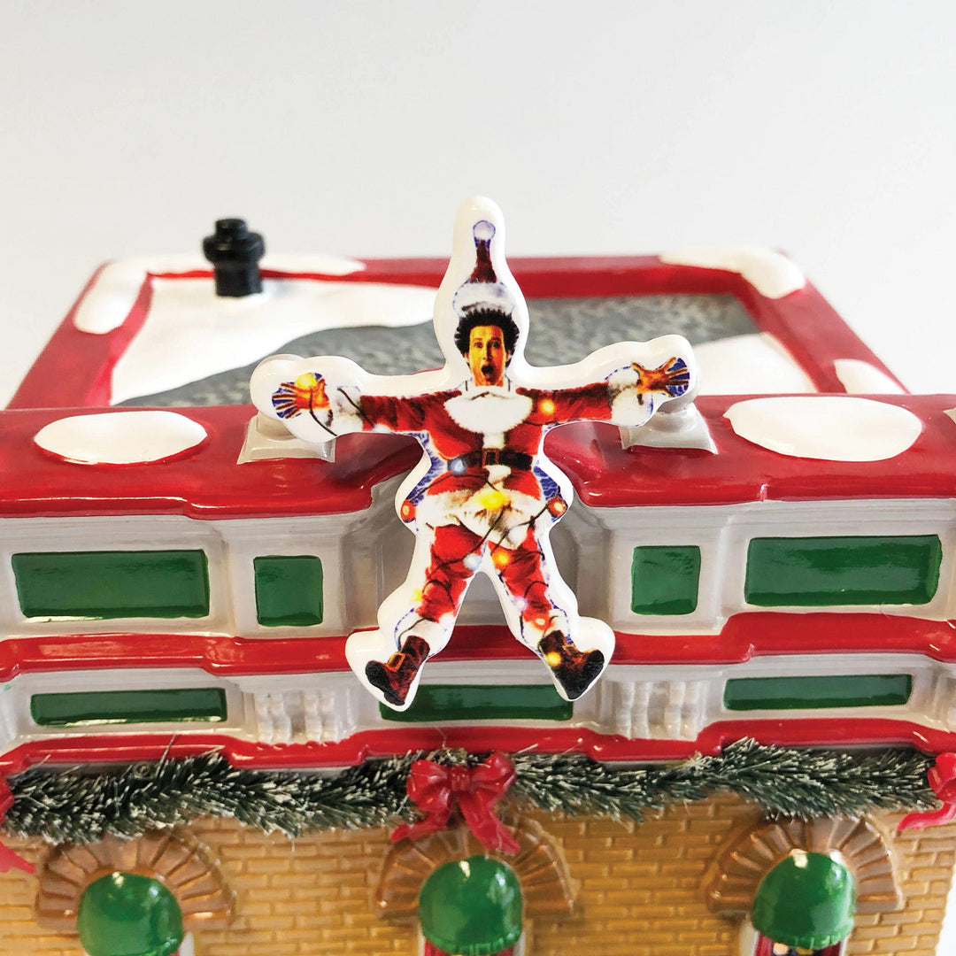 Department 56 Original Snow Village: Christmas Vacation Premiere At The Plaza sparkle-castle