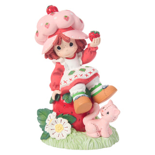 Precious Moments Strawberry Shortcake: Strawberry Shortcake Sitting on Strawberry Figurine sparkle-castle