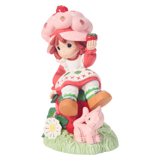Precious Moments Strawberry Shortcake: Strawberry Shortcake Sitting on Strawberry Figurine sparkle-castle