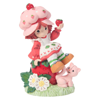 Precious Moments Strawberry Shortcake: Strawberry Shortcake Sitting on Strawberry Figurine sparkle-castle