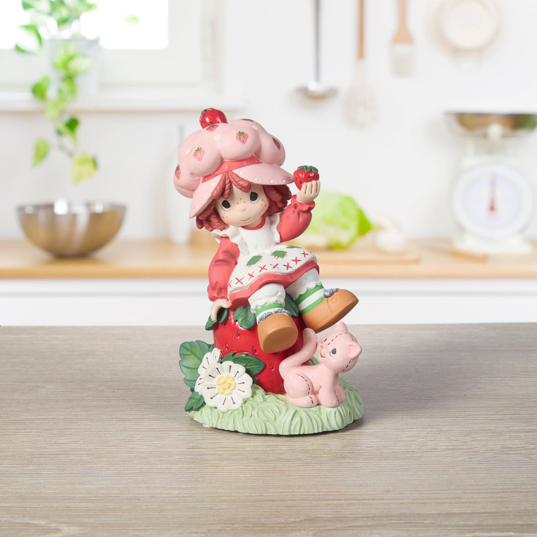 Precious Moments Strawberry Shortcake: Strawberry Shortcake Sitting on Strawberry Figurine sparkle-castle