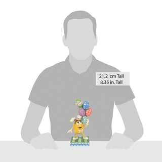 Jim Shore M&M'S: Yellow Easter M&M With Stacked Eggs Figurine sparkle-castle