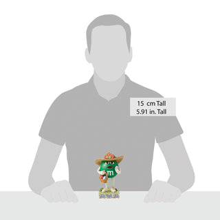 Jim Shore M&M'S: Green M&M With Easter Hat and Basket Figurine sparkle-castle