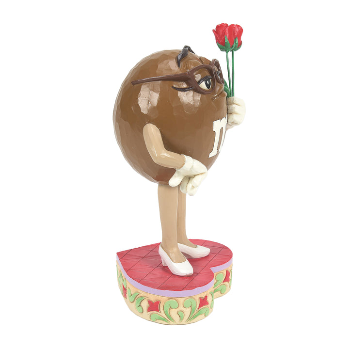 Jim Shore M&M'S: Brown M&M Holding Roses Figurine sparkle-castle