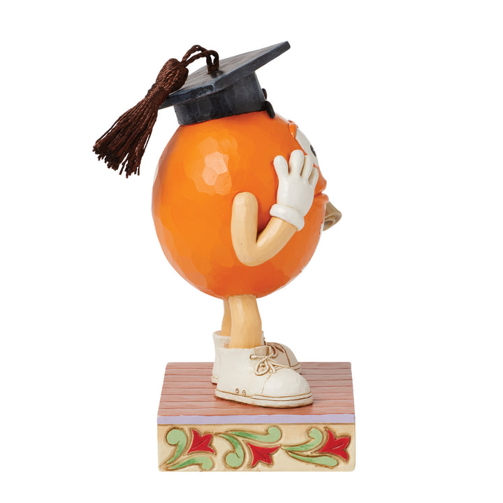 Jim Shore M&M'S: Orange M&M in Graduation Cap Figurine sparkle-castle