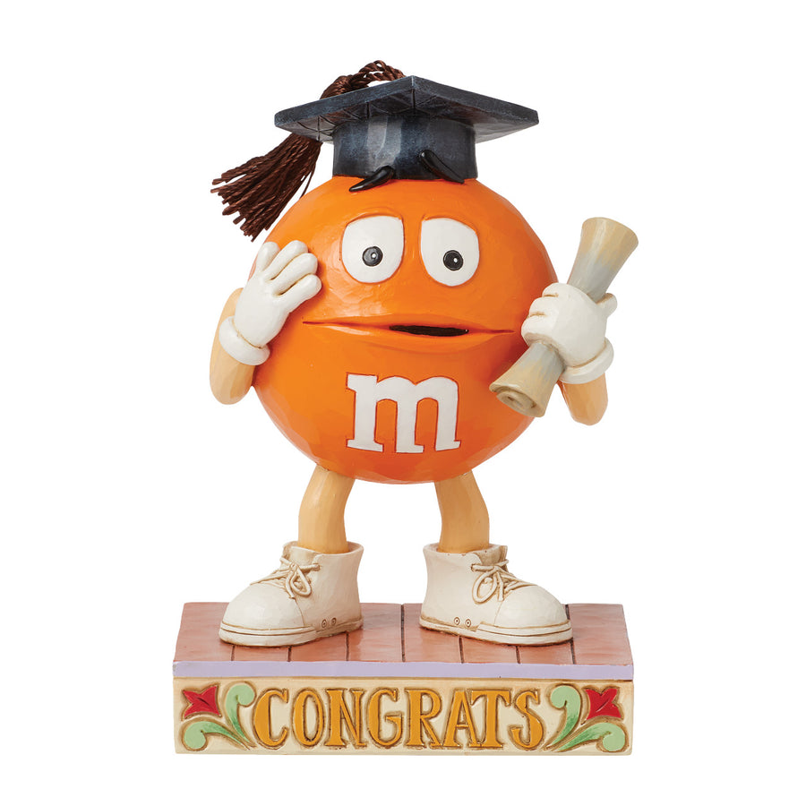 Jim Shore M&M'S: Orange M&M in Graduation Cap Figurine sparkle-castle