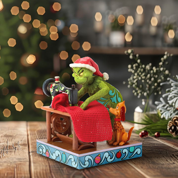 Jim Shore The Grinch: Grinch Sewing Santa Suit Figurine sparkle-castle