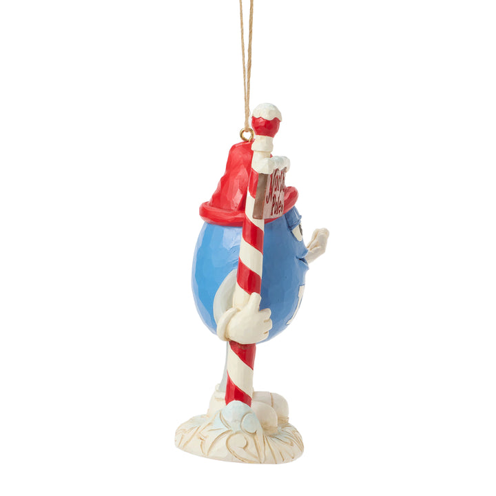 Jim Shore M&M's: Blue M&M With Strand by North Pole Sign Hanging Ornament