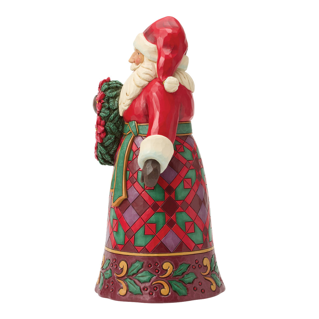Jim Shore Heartwood Creek: Santa Holding Poinsettia Wreath Figurine sparkle-castle