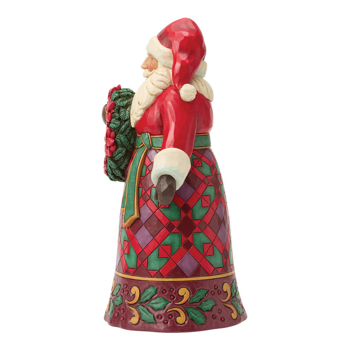 Jim Shore Heartwood Creek: Santa Holding Poinsettia Wreath Figurine sparkle-castle