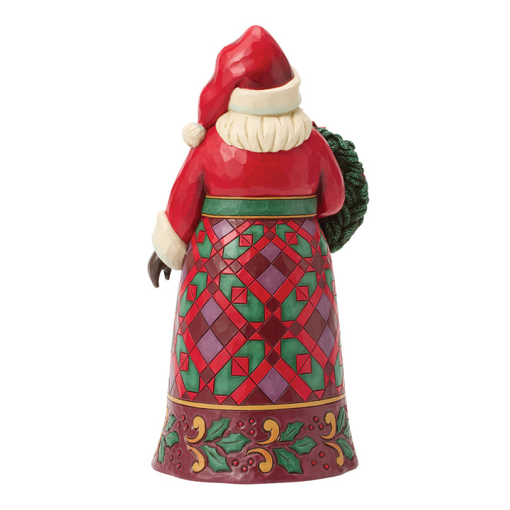 Jim Shore Heartwood Creek: Santa Holding Poinsettia Wreath Figurine sparkle-castle