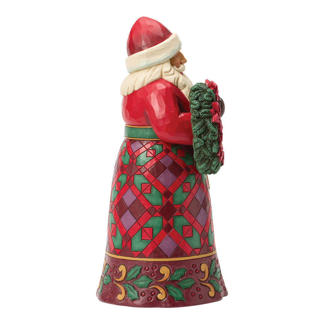 Jim Shore Heartwood Creek: Santa Holding Poinsettia Wreath Figurine sparkle-castle