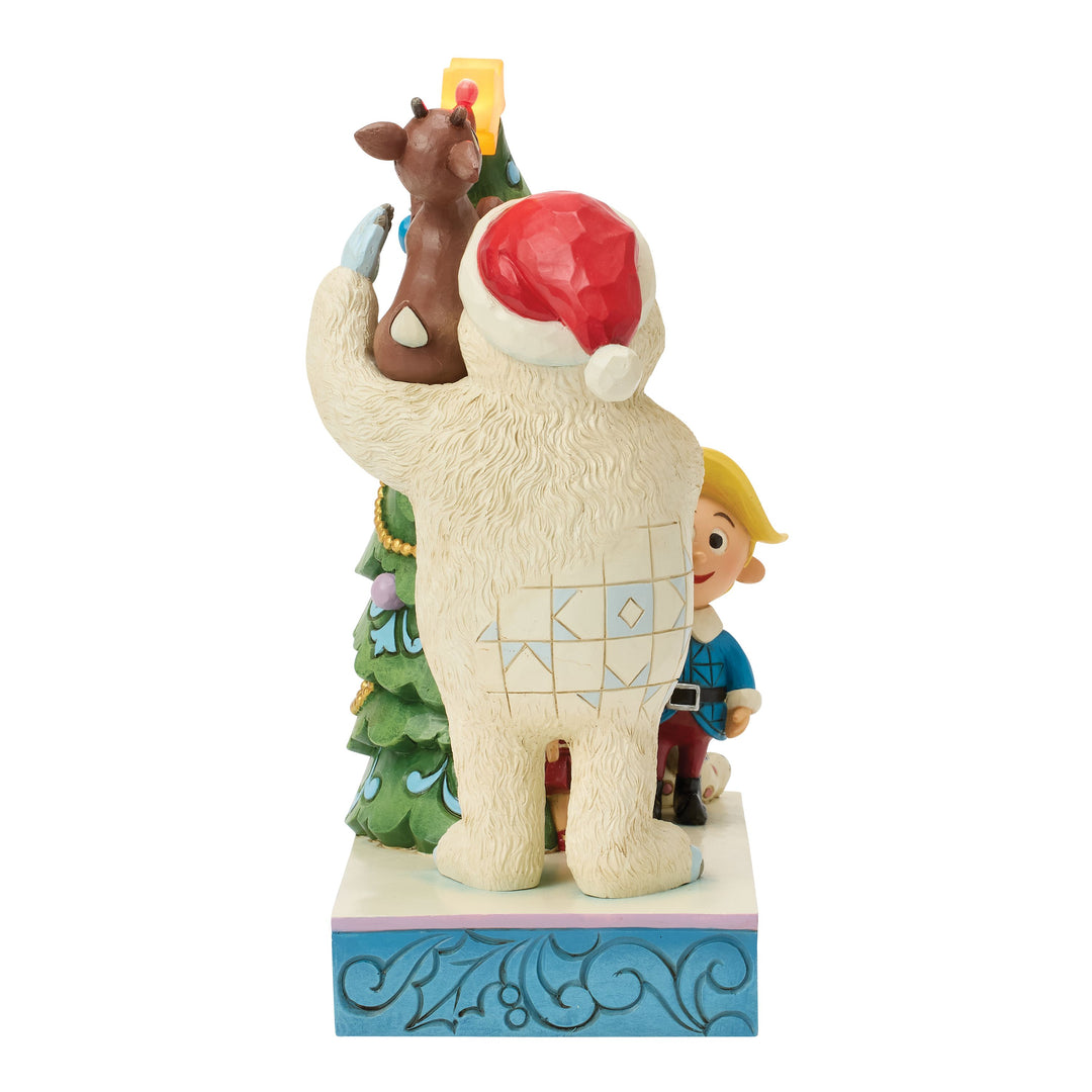 Jim Shore Rudolph Traditions: Bumble Holding Rudolph by Tree Figurine sparkle-castle