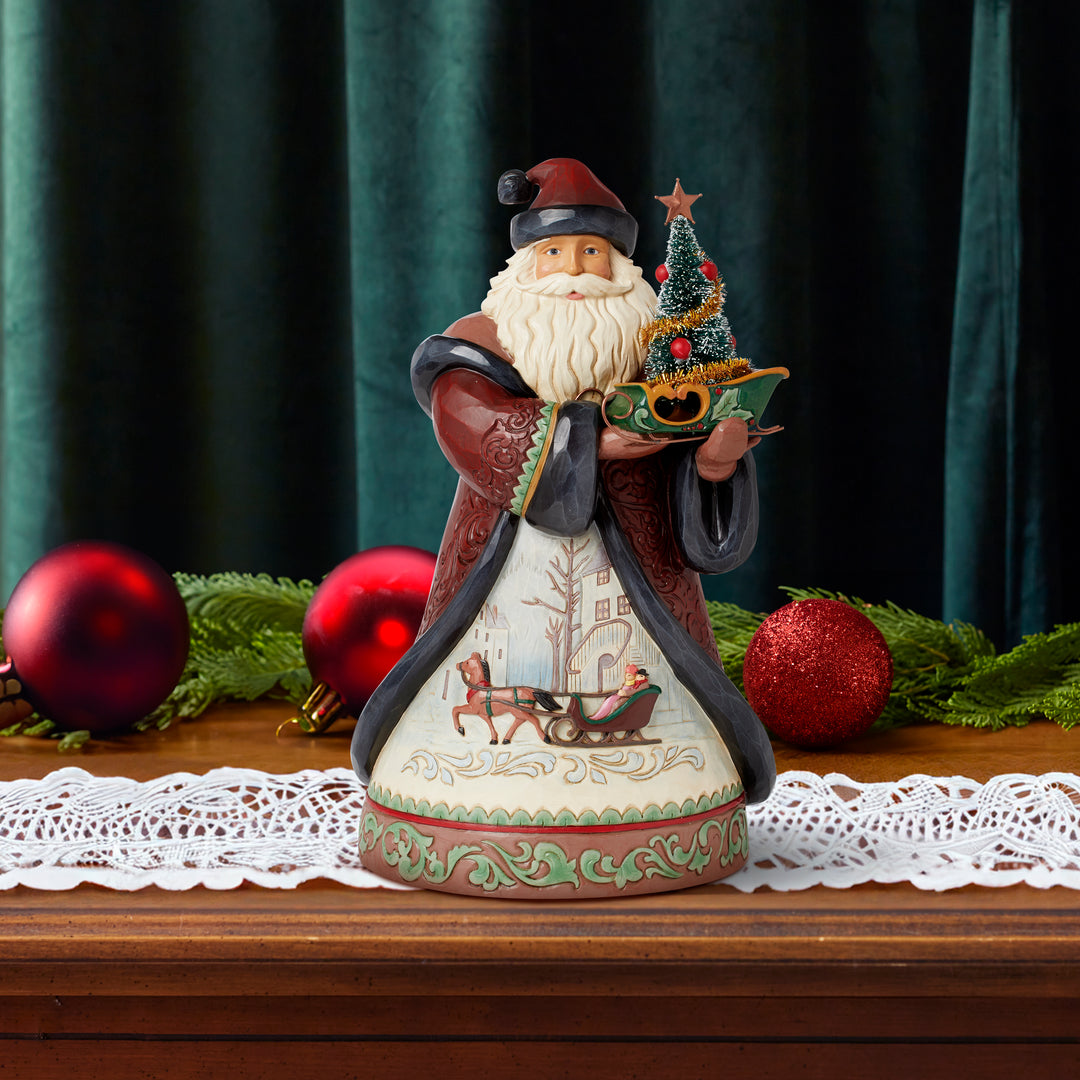 Jim Shore Heartwood Creek: Holiday Manor Santa Holding Small Sleigh and Sisal Tree Figurine sparkle-castle