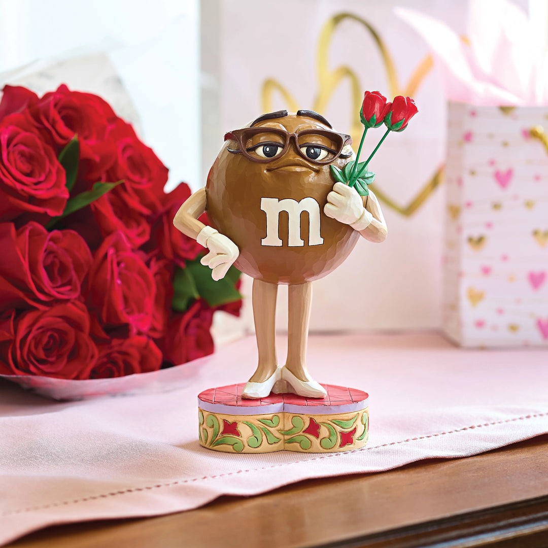 Jim Shore M&M'S: Brown M&M Holding Roses Figurine sparkle-castle