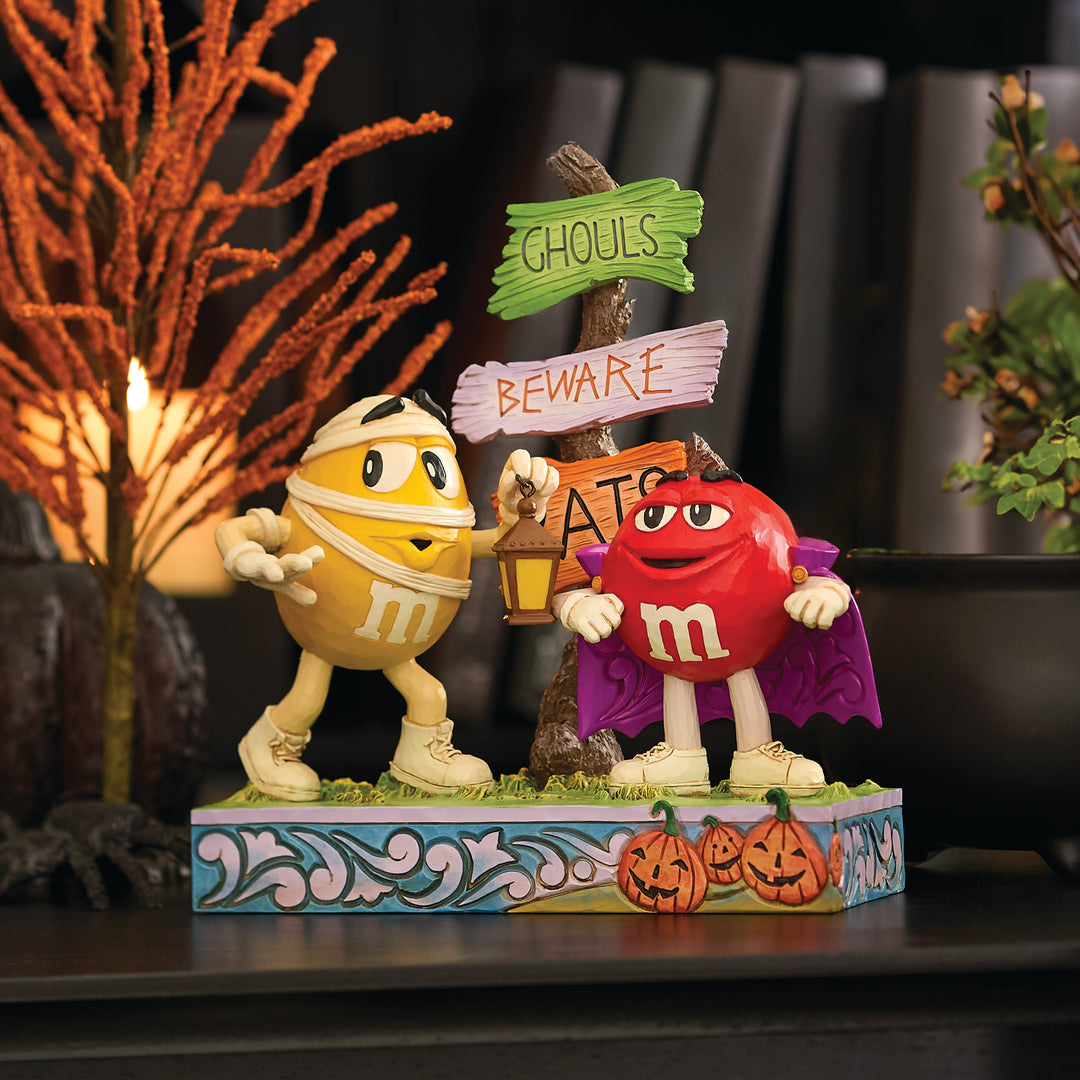 Jim Shore M&M'S: Red M&M Vampire With Yellow M&M Mummy Figurine sparkle-castle