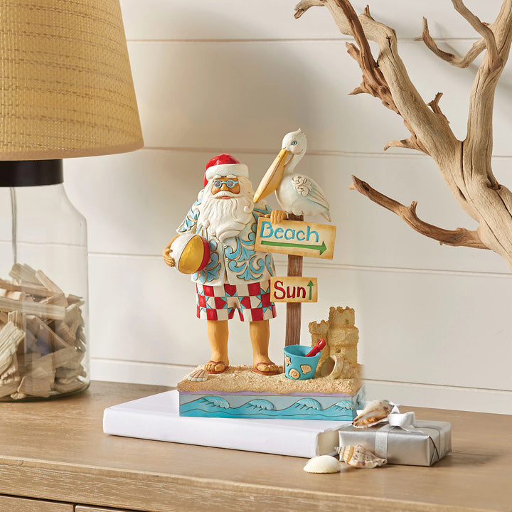 Jim Shore Heartwood Creek: Coastal Santa With Sign and Pelican Figurine sparkle-castle