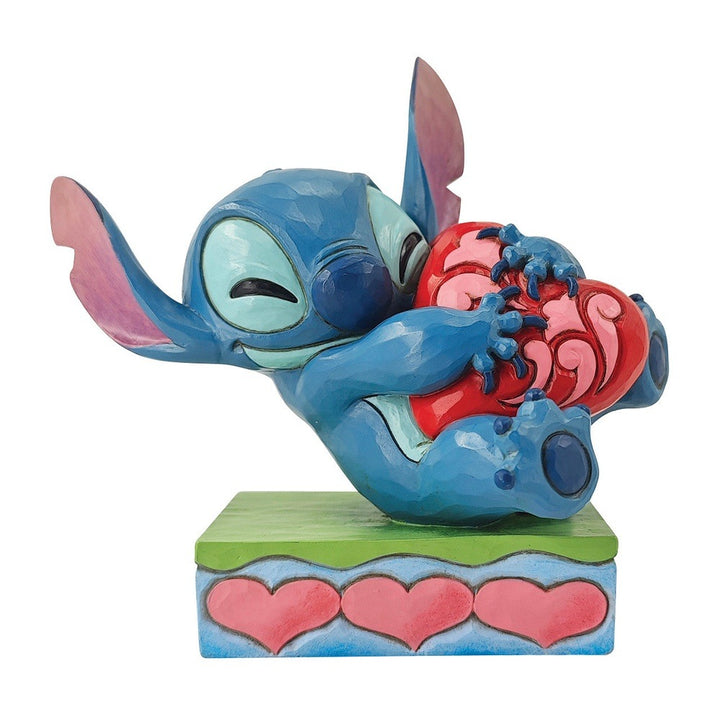 Jim Shore Disney Traditions: Stitch Hugging Heart Figurine sparkle-castle