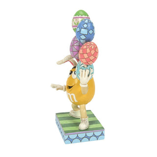 Jim Shore M&M'S: Yellow Easter M&M With Stacked Eggs Figurine sparkle-castle