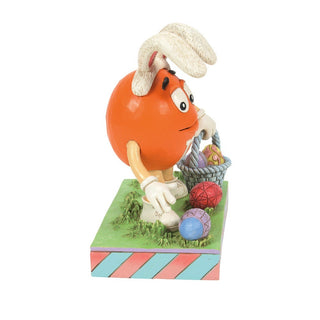 Jim Shore M&M'S: Orange M&M On Easter Egg Hunt Figurine sparkle-castle