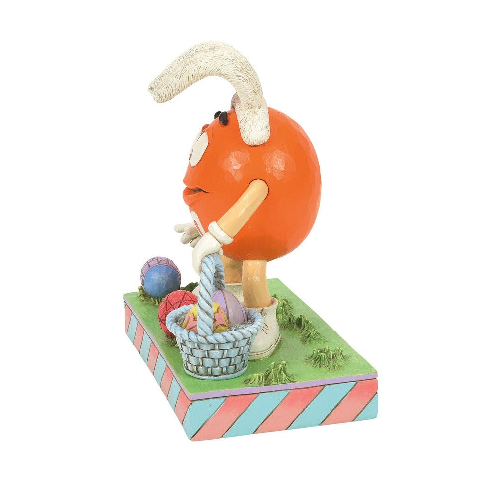 Jim Shore M&M'S: Orange M&M On Easter Egg Hunt Figurine sparkle-castle