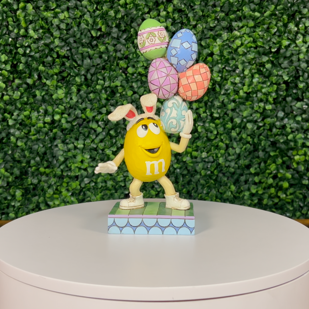 Jim Shore M&M'S: Yellow Easter M&M With Stacked Eggs Figurine
