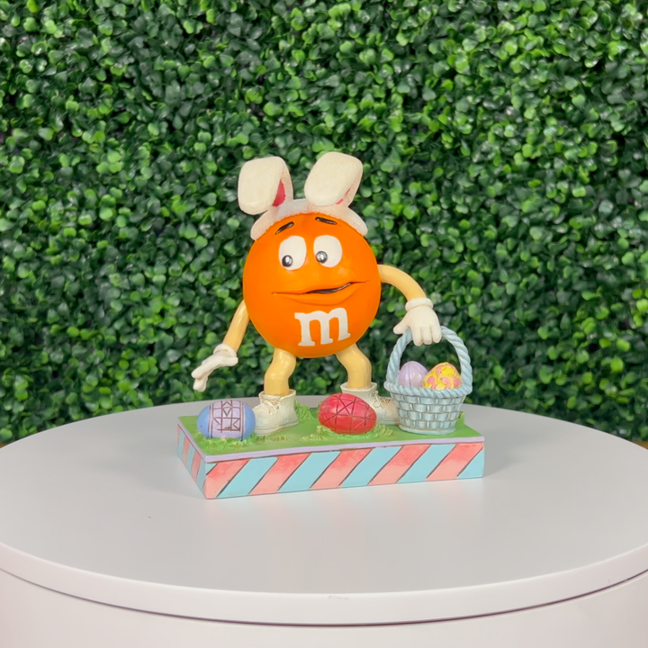 Jim Shore M&M'S: Orange M&M On Easter Egg Hunt Figurine