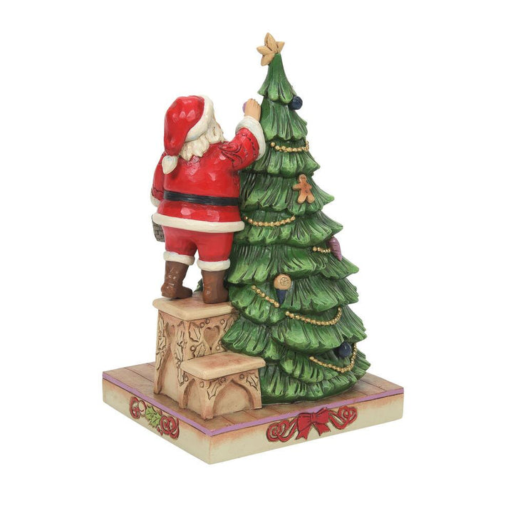Jim Shore Heartwood Creek: Santa Decorating Tree Figurine sparkle-castle