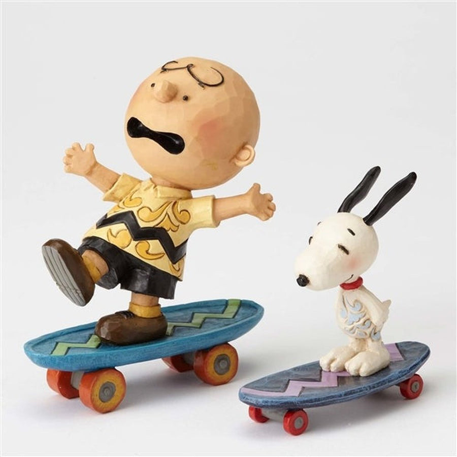 Jim Shore Peanuts: Charlie Brown & Snoopy on Skateboards Figurine sparkle-castle