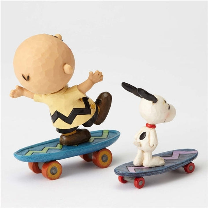 Jim Shore Peanuts: Charlie Brown & Snoopy on Skateboards Figurine sparkle-castle