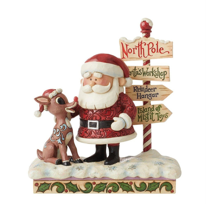 Jim Shore Rudolph Traditions: Rudolph and Santa Next to Sign Figurine sparkle-castle